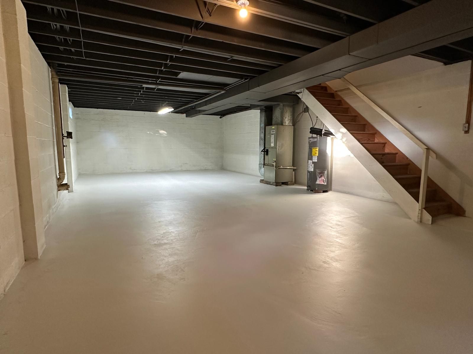 A basement painted and floored, ready to finish