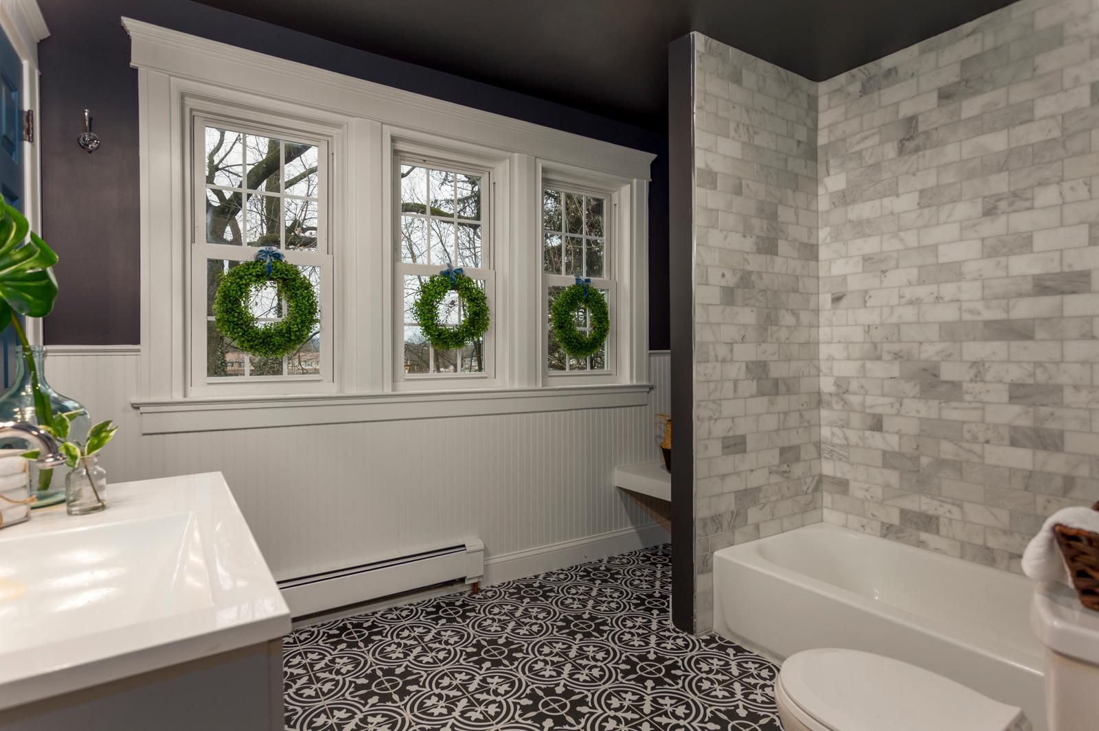 A tub with a subway-tile surround and a window