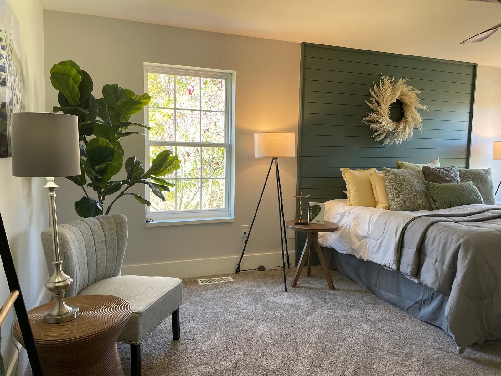 A bedroom with a blue shiplap wall