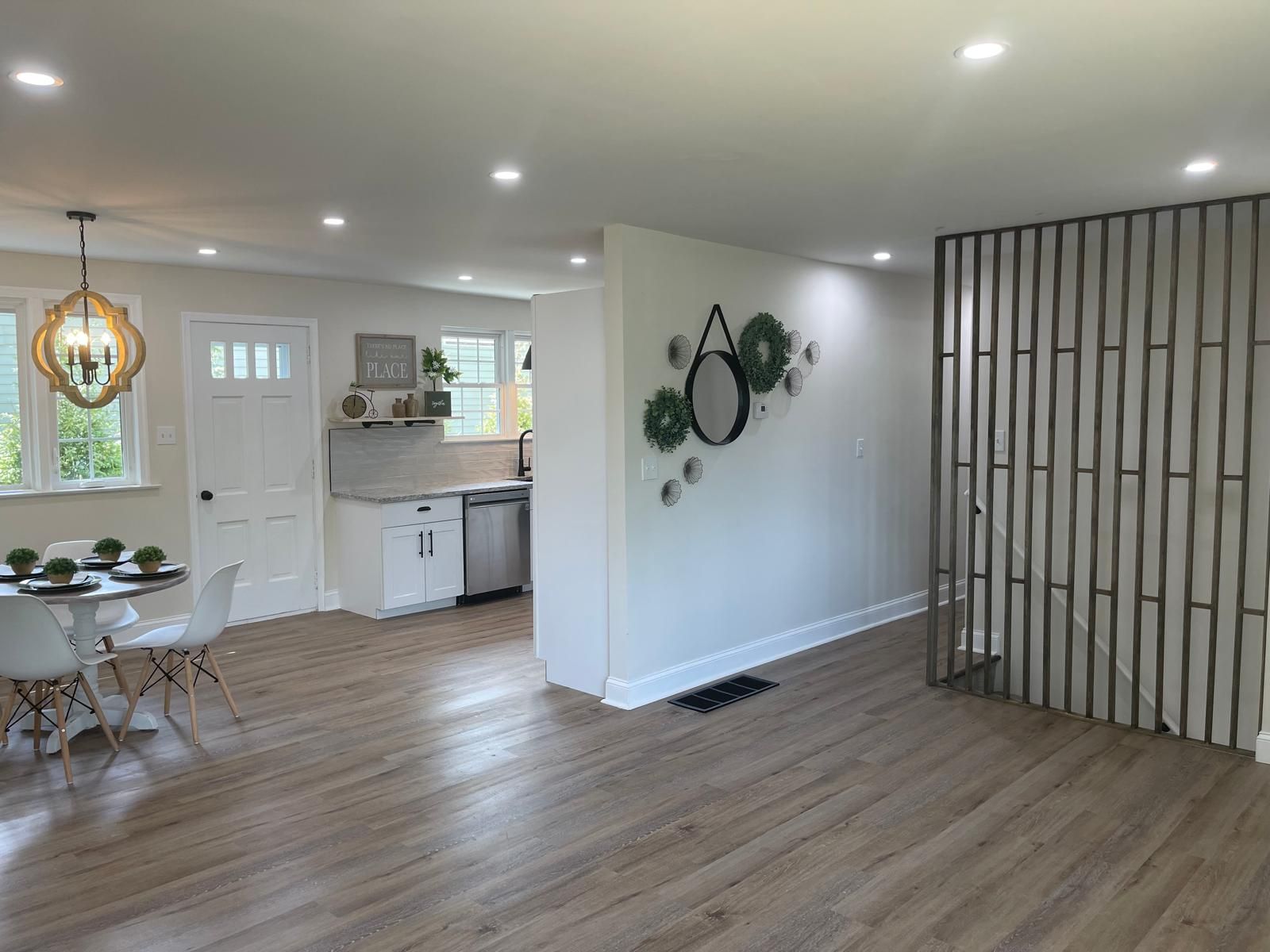 A kitchenette with white cabinets and a small island