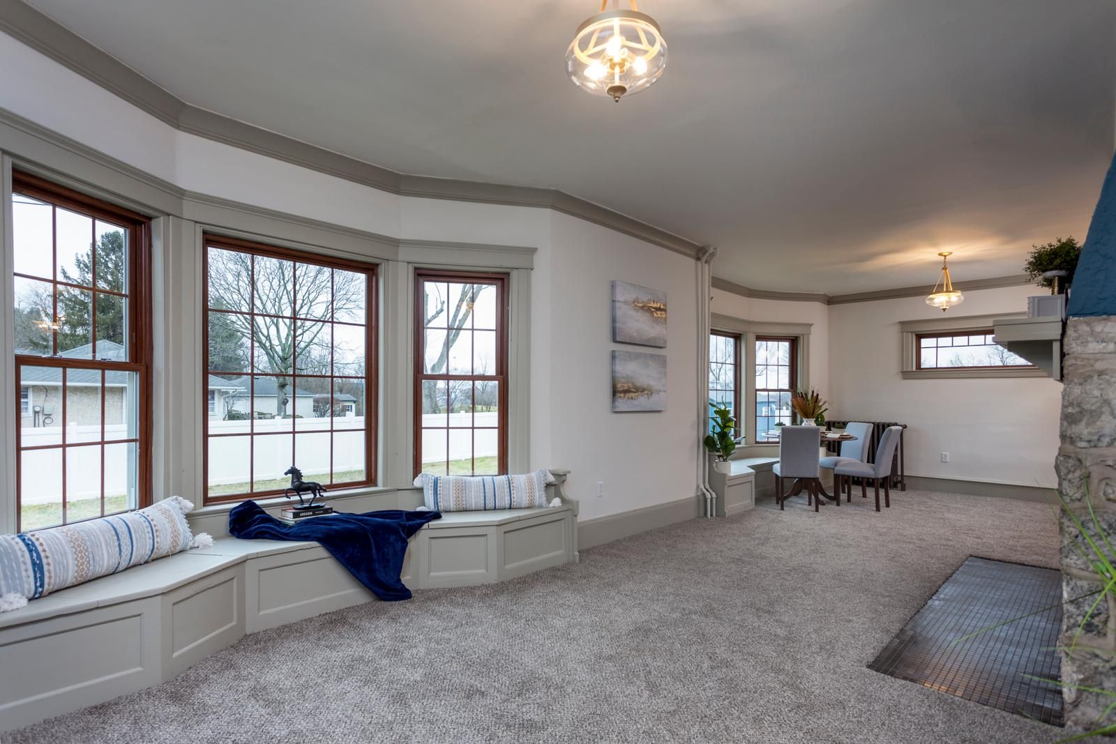 A bay window seat with a navy cushion